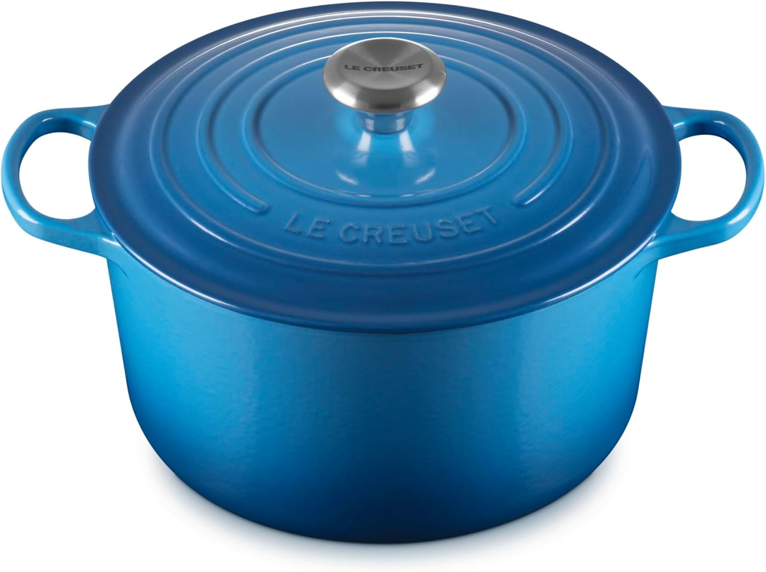 Blue Le Creuset enameled cast iron Dutch oven with a lid.